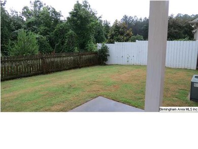 The backyard features a covered patio, private fen