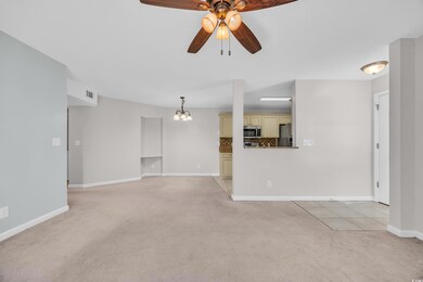 Unfurnished living room with ceiling fan with nota