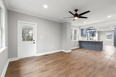 Unfurnished living room featuring baseboards, orna