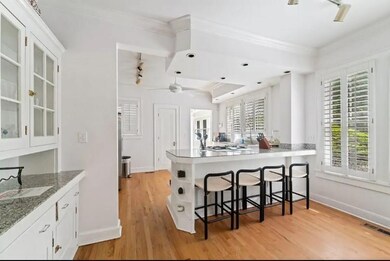 Kitchen featuring rail lighting, light hardwood / 