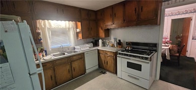 Kitchen with light countertops, visible vents, whi