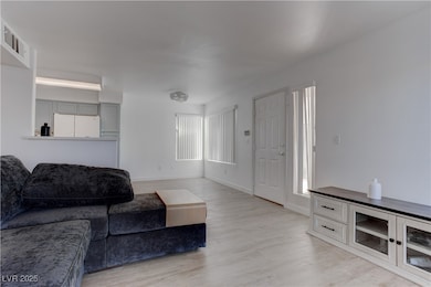 Living area featuring light wood-style flooring an