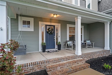 Doorway to property with covered porch