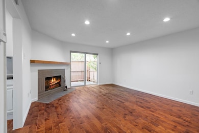 Unfurnished living room with a fireplace with flus