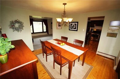 Enter the dining room with real hardwood flooring.