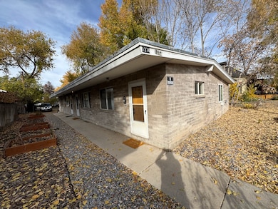 View of side of home featuring a vegetable garden and brick siding