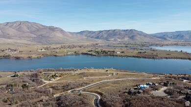 Birds eye view of property featuring a water and mountain view