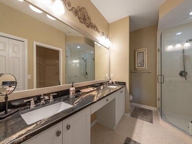 Bathroom with vanity, toilet, walk in shower, and