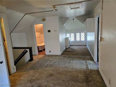 Corridor featuring carpet flooring and vaulted ceiling