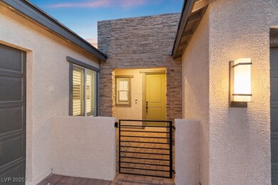 Exterior entry at dusk with stucco siding and ston