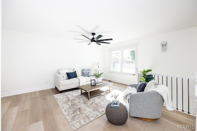 Living area with light wood-style flooring and a ceiling fan