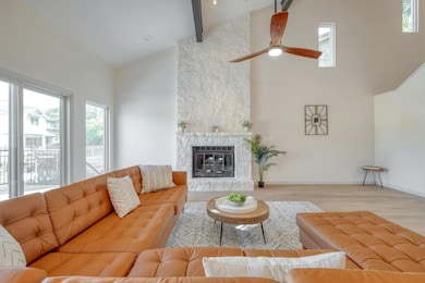 Living room with high vaulted ceiling, wood finis