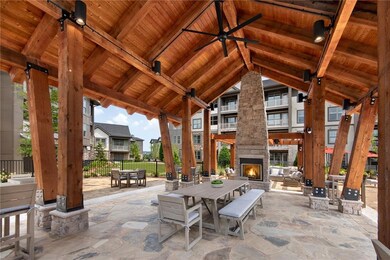 View of terrace featuring an outdoor stone firepla