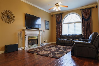 Beautiful floors, gas log fireplace, arched window