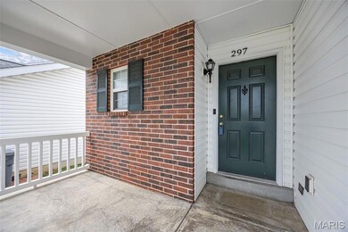 Property entrance with brick siding and covered porch