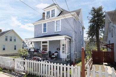 White picket fence and covered front porch make a