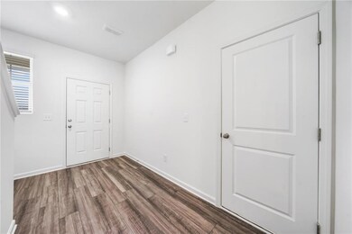 Foyer with baseboards, dark wood-style flooring, a