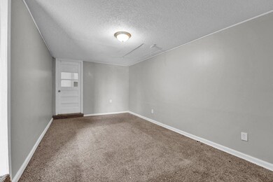 Spare room with attic access, baseboards, carpet f