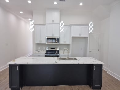 Modern kitchen with sleek white cabinets, stainles