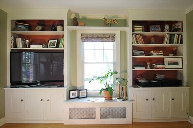 Built in bookcases and a window seat make this liv