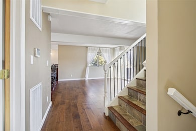 Entrance foyer featuring dark wood finished floors and stairway