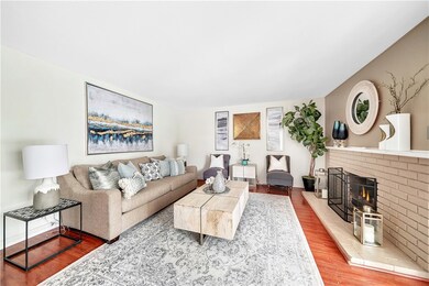 Beautiful Living Room with Wood Laminate Flooring and Fireplace with Mantel