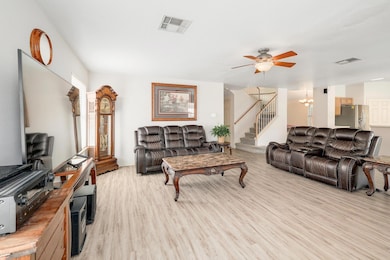 Living area featuring stairway, light wood finish