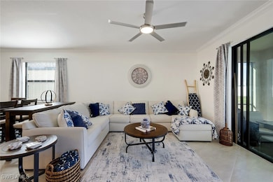 Living room featuring crown molding, tile patterne