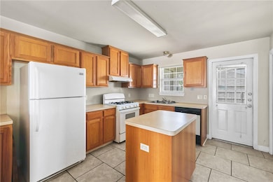 Kitchen with white appliances, under cabinet range