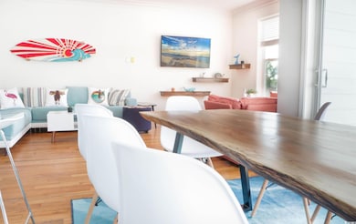 Dining room with light wood-style flooring and crown molding