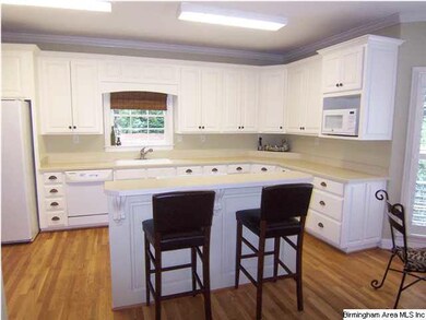 Open kitchen is light and airy with island and bar