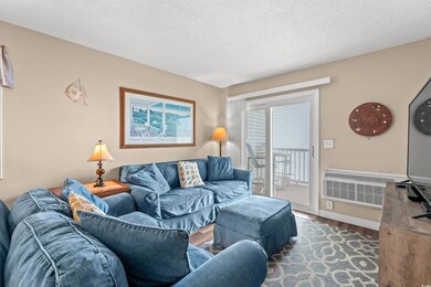 Living room featuring a textured ceiling and hardw