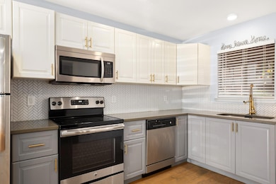 Kitchen with a sink, backsplash, appliances with 