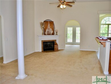 Open living room connects to the kitchen, dining a