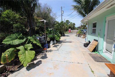 The side entry features numerous tropical plants