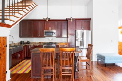 Open kitchen/living area with updated stainless st