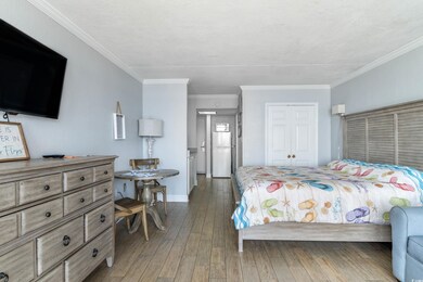 Bedroom with a closet, ornamental molding, white f