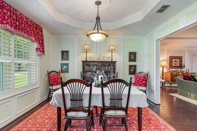 Dining space featuring a raised ceiling and open to the kitchen and living room