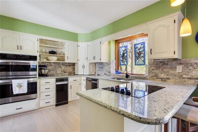 Kitchen with granite counters and stainless oven a