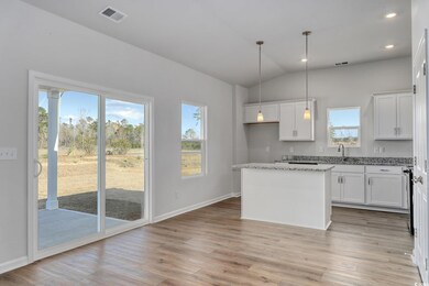 Kitchen with a kitchen island, white cabinets, and
