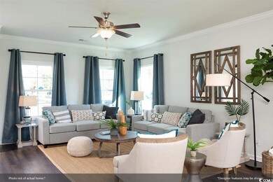 Living room featuring wood-type flooring, crown mo