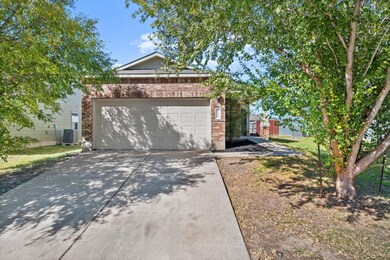 View of side of home featuring brick siding, conc
