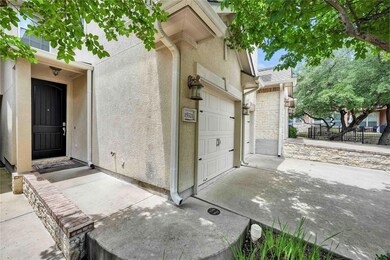 Property entrance featuring stone siding, concret