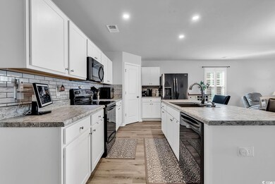 Kitchen with light wood finished floors, visible v