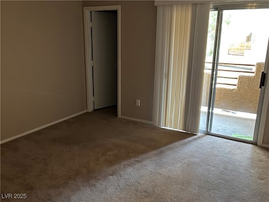 Carpeted empty room with baseboards