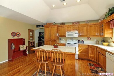Kitchen has hardwood floor, vaulted ceiling