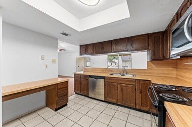 This kitchen features dark wood cabinetry, a built