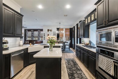 Kitchen with a farmhouse sink, light countertops, 