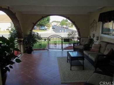 Covered front courtyard with tile floor, arched op