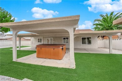 View of patio / terrace with fence and a hot tub